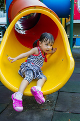 Image showing Asian kid sliding on Playground