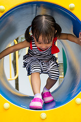 Image showing Asian Kid Crawling on Playground Tube