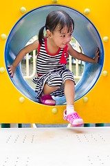 Image showing Asian Kid Crawling on Playground Tube