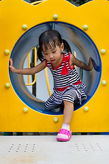 Image showing Asian Kid Crawling on Playground Tube