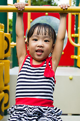 Image showing Asian Kid Hanging on bar 