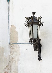 Image showing Retro street lantern on peeling plaster wall