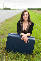 Image showing Beautiful smiling woman with suitcase