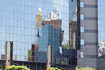 Image showing One modern building reflection in another building 
