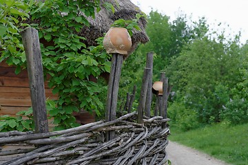 Image showing Lath fence with clay pots on top of stakes in open air museum, Kiev, Ukraine