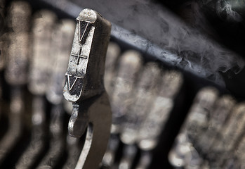 Image showing V hammer - old manual typewriter - mystery smoke