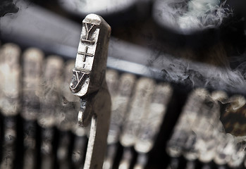 Image showing Y hammer - old manual typewriter - mystery smoke