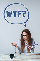 Image showing Young perturbed businesswoman looking away on light gray background