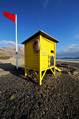 Image showing lifeguard chair red flag in s  coastline and summer 