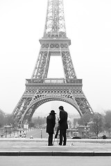 Image showing Couple taking photo of Eiffel tower in Paris.