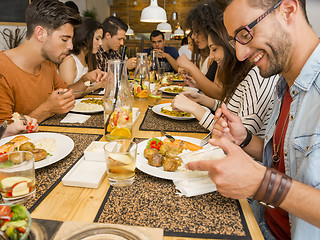 Image showing Friends lunching at the restaurant