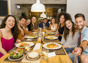 Image showing Friends at the restaurant making a selfie