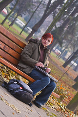 Image showing Redheaded girl in an autumn park