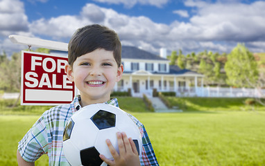 Image showing Boy Holding Ball In Front of House and Sale Sign