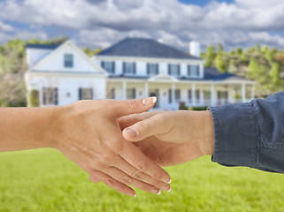 Image showing Man and Woman Shaking Hands in Front of New House