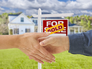 Image showing Shaking Hands in Front of New House and Sold Sign