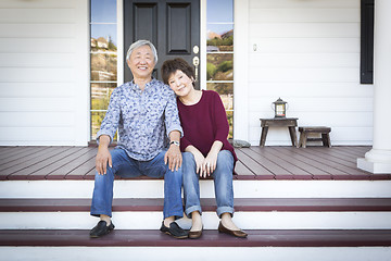 Image showing Senior Chinese Couple Sitting on Front Steps of Their House