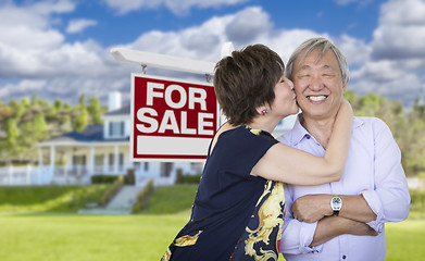 Image showing Affectionate Senior Chinese Couple In Front of House and Sign