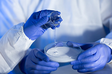 Image showing close up of scientists hands with chemicals in lab