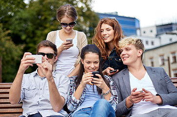 Image showing students or teenagers with smartphones at campus