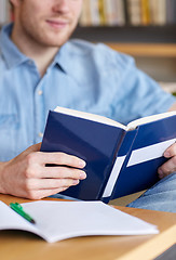 Image showing close up of student reading book at school