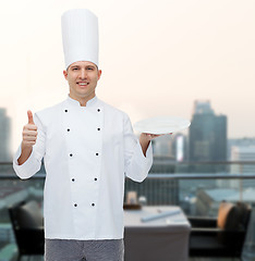 Image showing happy male chef cook showing thumbs up and plate