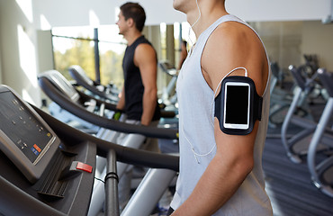 Image showing close up of man with smartphone in gym
