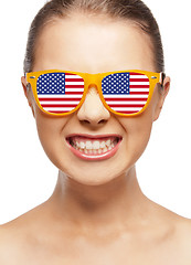 Image showing happy teenage girl in shades with american flag