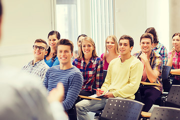 Image showing group of students and teacher with notebook