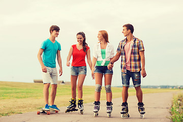 Image showing group of smiling teenagers with roller-skates