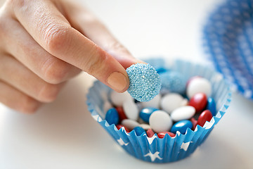 Image showing close up of hand with candies on independence day