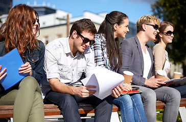 Image showing group of happy students with notebooks and coffee