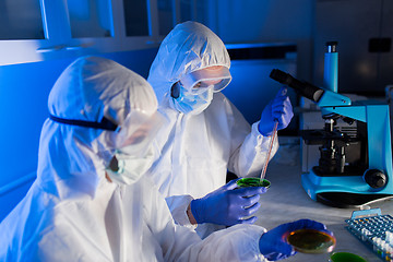 Image showing close up of scientists with test samples in lab