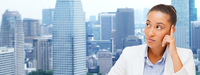 Image showing african businesswoman looking up and thinking