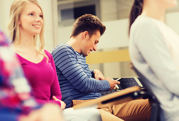 Image showing group of smiling students in lecture hall