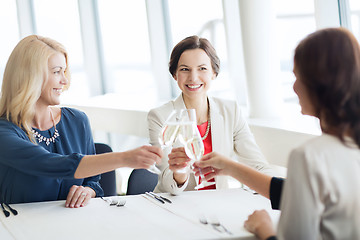 Image showing happy women drinking champagne at restaurant