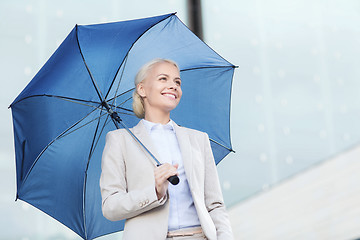Image showing young smiling businesswoman with umbrella outdoors
