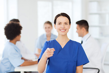 Image showing happy doctor over group of medics at hospital