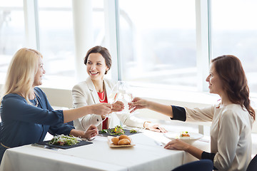 Image showing happy women drinking champagne at restaurant