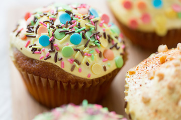 Image showing close up of glazed cupcakes or muffins on table