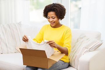 Image showing happy african young woman with parcel box at home