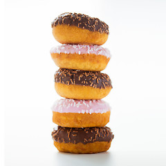 Image showing close up of glazed donuts pile over white