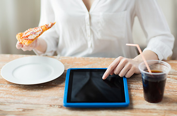 Image showing close up of woman with tablet pc having dinner