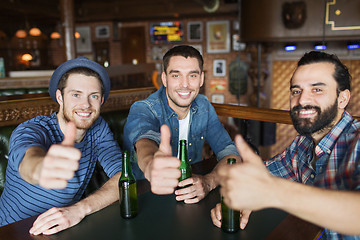 Image showing happy male friends drinking beer at bar or pub