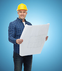 Image showing smiling male builder in helmet with blueprint