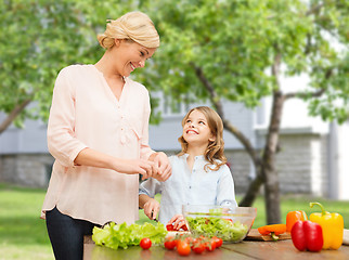 Image showing happy family cooking vegetable salad for dinner