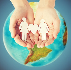 Image showing female hands with paper gay couple figures