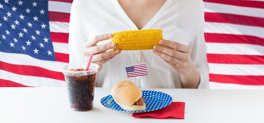 Image showing woman hands holding corn with hot dog and cola