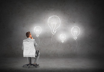 Image showing businessman in office chair over white board