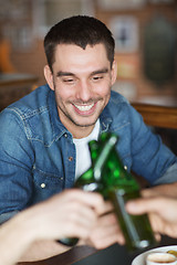 Image showing happy male friends drinking beer at bar or pub